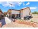 Backyard featuring a covered patio, lush plants, and a well-maintained yard at 1057 Neil Armstrong Cir, Las Vegas, NV 89145