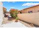 Private backyard features a patio area and colorful flower bushes adding a touch of nature at 1057 Neil Armstrong Cir, Las Vegas, NV 89145