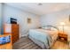 A cozy bedroom with soft bedding, dresser, and bedside table at 1057 Neil Armstrong Cir, Las Vegas, NV 89145