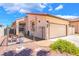 Well-kept single-story house with an enclosed courtyard, desert landscaping, and attached two-car garage at 1057 Neil Armstrong Cir, Las Vegas, NV 89145