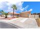 Inviting single-story home featuring a desert landscape, palm trees, and a convenient two-car garage at 1057 Neil Armstrong Cir, Las Vegas, NV 89145