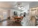 Bright kitchen and dining area with white cabinets, stainless steel appliances, and stylish light fixtures at 1057 Neil Armstrong Cir, Las Vegas, NV 89145