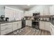 Bright kitchen featuring white cabinetry, stainless steel appliances, and modern countertops at 1057 Neil Armstrong Cir, Las Vegas, NV 89145