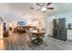Open-concept living space with a dining area, stainless steel refrigerator, and a comfortable seating arrangement at 1057 Neil Armstrong Cir, Las Vegas, NV 89145