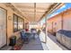Spacious covered patio with a dining set, chairs, and a BBQ grill at 1057 Neil Armstrong Cir, Las Vegas, NV 89145