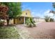 Spacious backyard with a covered patio, desert landscaping, and colorful flowers at 1117 Coral Crystal Ct, North Las Vegas, NV 89032