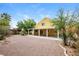 Expansive backyard with desert landscaping, mature trees, and a covered patio at 1117 Coral Crystal Ct, North Las Vegas, NV 89032