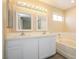 Bright bathroom featuring double sinks, a soaking tub, and elegant fixtures at 1117 Coral Crystal Ct, North Las Vegas, NV 89032