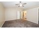 Spacious bedroom featuring neutral carpeting and a ceiling fan, leading to an ensuite bathroom at 1117 Coral Crystal Ct, North Las Vegas, NV 89032