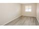 Empty bedroom with wood-look flooring and bright natural light at 1117 Coral Crystal Ct, North Las Vegas, NV 89032