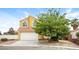 Charming two-story home featuring a well-maintained lawn, complemented by a spacious two-car garage at 1117 Coral Crystal Ct, North Las Vegas, NV 89032