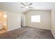 Spacious primary bedroom boasts neutral colors, carpet, a ceiling fan, and a private ensuite at 1117 Coral Crystal Ct, North Las Vegas, NV 89032