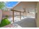 Backyard with a covered patio with fans, pool, spa, and brick wall at 11695 Rossovino St, Las Vegas, NV 89183