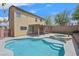 Inviting backyard showcasing a sparkling pool and jacuzzi with a covered patio, perfect for outdoor relaxation at 11695 Rossovino St, Las Vegas, NV 89183
