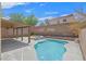 Backyard pool and spa, set against block wall, is complimented by a covered patio at 11695 Rossovino St, Las Vegas, NV 89183