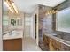 Bathroom with double vanity, shower with marble surround, and tile flooring at 11695 Rossovino St, Las Vegas, NV 89183