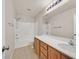 Bathroom featuring tile floors, a bathtub with shower, and a wooden vanity with sink at 11695 Rossovino St, Las Vegas, NV 89183