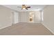 Large bedroom with neutral paint and carpet, ceiling fan, and access to the ensuite bathroom at 11695 Rossovino St, Las Vegas, NV 89183