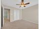 Neutral bedroom featuring carpeted floors, a ceiling fan, and double door closet at 11695 Rossovino St, Las Vegas, NV 89183