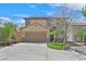 Charming two-story home featuring a well-manicured lawn, a two-car garage, and a welcoming facade at 11695 Rossovino St, Las Vegas, NV 89183