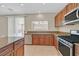 Updated kitchen featuring stainless steel appliances, granite countertops, and an open plan for entertaining at 11695 Rossovino St, Las Vegas, NV 89183