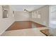 Spacious living room with hardwood flooring, a ceiling fan, recessed lighting, and sliding glass doors for ample natural light at 11695 Rossovino St, Las Vegas, NV 89183