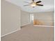 Upstairs loft space featuring carpet, a ceiling fan, and staircase railing with views to a second room at 11695 Rossovino St, Las Vegas, NV 89183