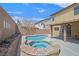 Backyard oasis featuring a pool, spa, covered patio, and privacy walls at 11695 Rossovino St, Las Vegas, NV 89183