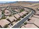 View of a community of single-Gathering homes in a desert landscape at 12844 New Providence St, Las Vegas, NV 89141