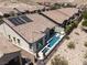 Aerial view of a home featuring solar panels, desert landscaping, and a pool at 12844 New Providence St, Las Vegas, NV 89141