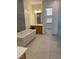 Bright bathroom featuring a soaking tub, walk-in closet, and natural light at 12844 New Providence St, Las Vegas, NV 89141