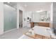 Bright bathroom with walk-in shower, soaking tub, modern fixtures, and spacious vanity at 12844 New Providence St, Las Vegas, NV 89141
