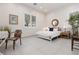 Bright bedroom with white walls, tile flooring, a queen bed, and natural light from plantation-shuttered windows at 12844 New Providence St, Las Vegas, NV 89141