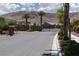 Gated entrance to the community featuring desert landscaping and a nearby sidewalk at 12844 New Providence St, Las Vegas, NV 89141