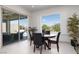 Open dining area with lots of natural light, modern furnishings, and views from sliding glass doors at 12844 New Providence St, Las Vegas, NV 89141