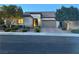 Well-maintained single-story home with a tile roof, two-car garage, and landscaped front yard at dusk at 12844 New Providence St, Las Vegas, NV 89141