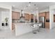 Open kitchen with a large island, stainless steel appliances, and modern pendant lighting at 12844 New Providence St, Las Vegas, NV 89141
