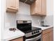 The kitchen boasts a modern range, bright white counters and cabinetry, plus stainless steel appliances at 12844 New Providence St, Las Vegas, NV 89141