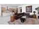 Open-concept living area with modern furnishings, stylish decor, and bright, natural light from windows at 12844 New Providence St, Las Vegas, NV 89141