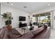 Bright, open living room showcasing a leather sofa, modern decor, and outdoor access at 12844 New Providence St, Las Vegas, NV 89141