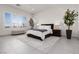 Serene main bedroom with bright windows, bench seating, and stylish bedside tables at 12844 New Providence St, Las Vegas, NV 89141