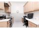Dual purpose office/kitchen with built-in desk, cabinets, and modern appliances for convenience at 12844 New Providence St, Las Vegas, NV 89141