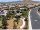 Aerial view of a playground area with play structures and a nearby community park at 12844 New Providence St, Las Vegas, NV 89141