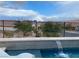 Enjoy the mountain views from the edge of the sparkling pool with a rainbow in the distance at 12844 New Providence St, Las Vegas, NV 89141