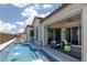 Beautiful backyard featuring a pool with fountains and a covered patio seating area at 12844 New Providence St, Las Vegas, NV 89141