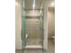 Glass enclosed shower with built-in seat, mosaic tile, and shower head at 12844 New Providence St, Las Vegas, NV 89141
