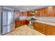 Well-lit kitchen featuring wood cabinetry, granite countertops, and stainless steel appliances at 150 Las Vegas Blvd # 2016, North Las Vegas, NV 89101