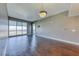 Living room with hardwood floors, large windows with blinds, and mounted TV at 150 Las Vegas Blvd # 2016, North Las Vegas, NV 89101