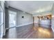 Living room with hardwood floors, access to a balcony, and view into the kitchen at 150 Las Vegas Blvd # 2016, North Las Vegas, NV 89101