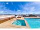 Stylish rooftop pool area with cushioned lounge seating, spa, and a glass barrier for unobstructed views at 150 Las Vegas Blvd # 2016, North Las Vegas, NV 89101